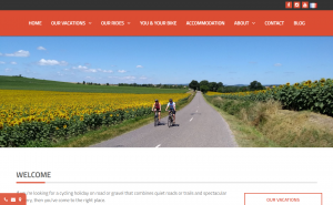 A clean website front page with a red header menu followed by an image of two cyclists riding through sunflowers with text describing the business underneath
