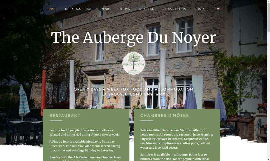 A screenshot of the Auberge du Noyer homepage showing the building, the title, the logo, and some introduction to the site